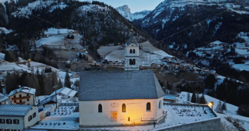Aerial drone view of the Eglise de Sainte-Lucie in the Colle Santa Lucia comune in Dolomites, Italy - Starpik Stock