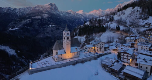 Aerial drone view of the Eglise de Sainte-Lucie in the Colle Santa Lucia comune in Dolomites, Italy - Starpik Stock