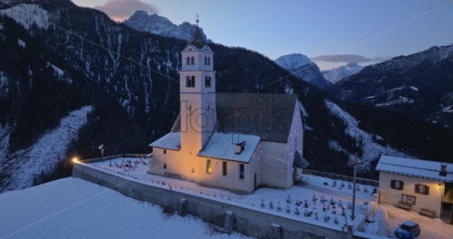 Aerial drone view of the Eglise de Sainte-Lucie in the Colle Santa Lucia comune in Dolomites, Italy - Starpik Stock