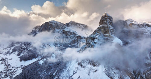 Aerial drone view of the Gardena Pass high mountain pass in the clouds, in the Dolomites, Italy - Starpik Stock