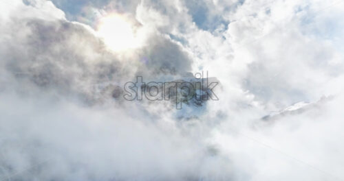 Aerial drone view of the Gardena Pass high mountain pass in the clouds, in the Dolomites, Italy - Starpik Stock