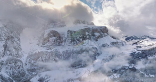 Aerial drone view of the Gardena Pass high mountain pass in the clouds, in the Dolomites, Italy - Starpik Stock