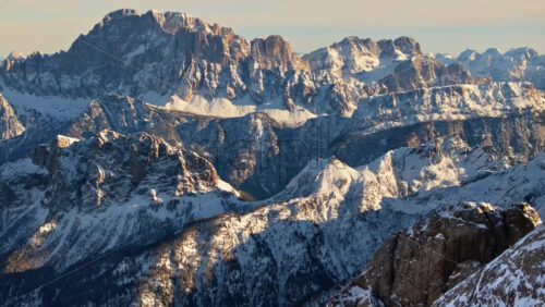 Aerial drone view of the Marmolada mountain in the Dolomites, northeastern Italy with the blue sky on the background - Starpik Stock