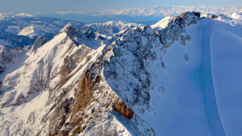 Aerial drone view of the Marmolada mountain in the Dolomites, northeastern Italy with the blue sky on the background - Starpik Stock