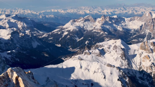 Aerial drone view of the Marmolada mountain in the Dolomites, northeastern Italy with the blue sky on the background - Starpik Stock