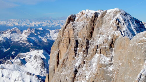 Aerial drone view of the Marmolada mountain in the Dolomites, northeastern Italy with the blue sky on the background - Starpik Stock