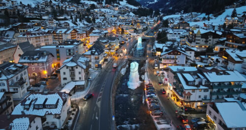 Aerial drone view of the Ortisei town covered in snow, within the Dolomites, in northern Italy - Starpik Stock