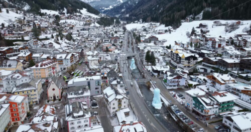 Aerial drone view of the Ortisei town covered in snow, within the Dolomites, in northern Italy - Starpik Stock