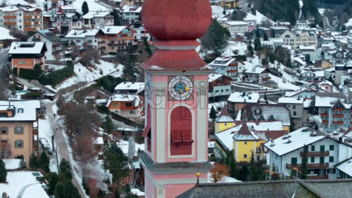 Aerial drone view of the Ortisei town covered in snow, within the Dolomites, in northern Italy - Starpik Stock
