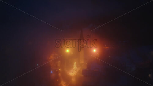 Aerial drone view of the San Lorenzo Church illuminated at night in the Selva di Cadore comune in Dolomites, Italy - Starpik Stock