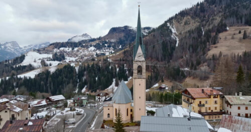 Aerial drone view of the San Lorenzo Church in the Selva di Cadore comune, in the Dolomites, Italy - Starpik Stock