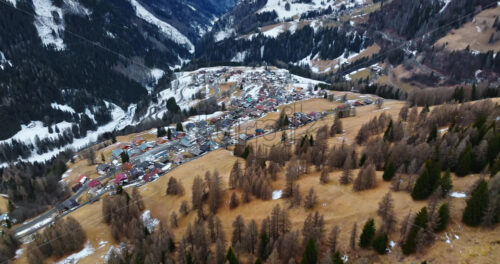 Aerial drone view of the Selva di Cadore commune surrounded by the Dolomites mountains in Italy - Starpik Stock