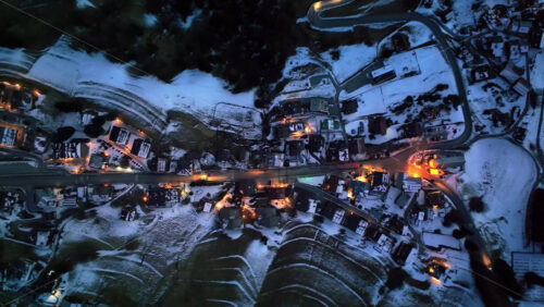 Aerial drone view of the Selva di Cadore comune illuminated at night in the province of Belluno, Dolomites, Italy - Starpik Stock