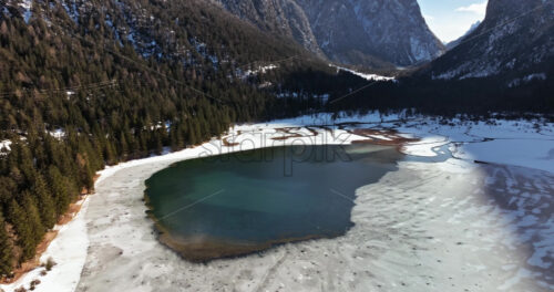 Aerial drone view of the Toblacher See lake in the municipality of Toblach in South Tyrol, Italy - Starpik Stock