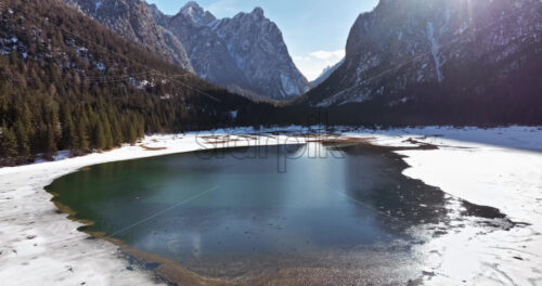 Aerial drone view of the Toblacher See lake in the municipality of Toblach in South Tyrol, Italy - Starpik Stock