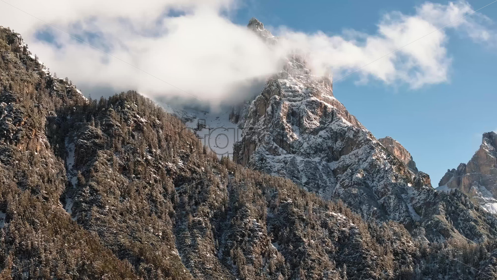 Aerial drone view of the mountains in the clouds, in the Dolomites, Italy - Starpik Stock
