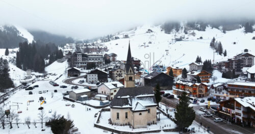 Arabba, Italy – January 8, 2025: Aerial drone view of the Arabba mountain village in the Dolomites, Italy - Starpik Stock