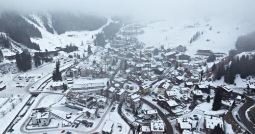 Arabba, Italy – January 8, 2025: Aerial drone view of the Arabba mountain village in the Dolomites, Italy - Starpik Stock