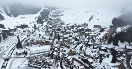 Arabba, Italy – January 8, 2025: Aerial drone view of the Arabba mountain village in the Dolomites, Italy - Starpik Stock