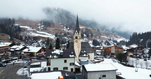 Arabba, Italy – January 8, 2025: Aerial drone view of the Arabba mountain village in the Dolomites, Italy - Starpik Stock