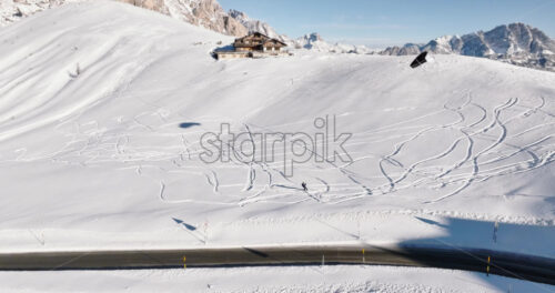 Belluno, Italy – January 12, 2025: Aerial drone view of a sportsman snowkiting on the Giau Pass in the Dolomites, Italy - Starpik Stock