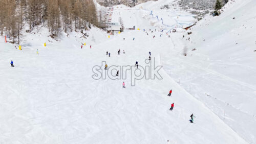 Colfosco, Italy – January 11, 2025: Aerial drone view of people skiing in Colfosco in South Tyrol, Dolomites, Northern Italy - Starpik Stock