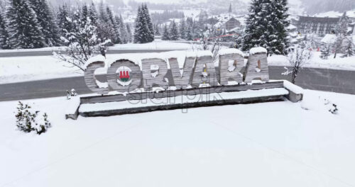 Corvara in Badia, Italy – January 9, 2025: Aerial drone view of a sign of the Corvara covered in snow, in South Tyrol, Dolomites, in northern Italy - Starpik Stock