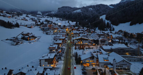 Corvara in Badia, Italy – January 9, 2025: Aerial drone view of the Corvara village covered in snow at blue hour, in South Tyrol, Dolomites, in northern Italy - Starpik Stock