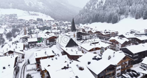 Corvara in Badia, Italy – January 9, 2025: Aerial drone view of the Corvara village covered in snow, in South Tyrol, Dolomites, in northern Italy - Starpik Stock