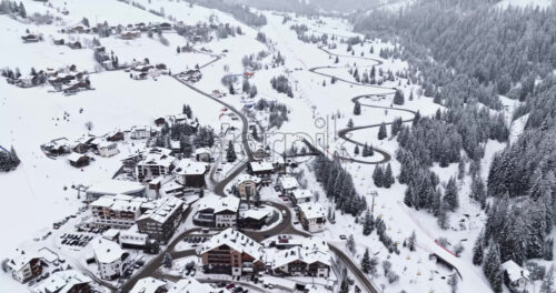 Corvara in Badia, Italy – January 9, 2025: Aerial drone view of the Corvara village covered in snow, in South Tyrol, Dolomites, in northern Italy - Starpik Stock