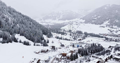 Corvara in Badia, Italy – January 9, 2025: Aerial drone view of the Corvara village covered in snow, in South Tyrol, Dolomites, in northern Italy - Starpik Stock