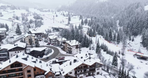 Corvara in Badia, Italy – January 9, 2025: Aerial drone view of the Corvara village covered in snow, in South Tyrol, Dolomites, in northern Italy - Starpik Stock