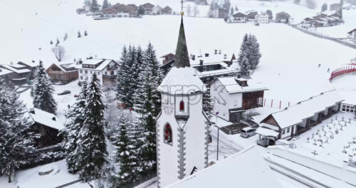 Corvara in Badia, Italy – January 9, 2025: Aerial drone view of the Corvara village covered in snow, in South Tyrol, Dolomites, in northern Italy - Starpik Stock