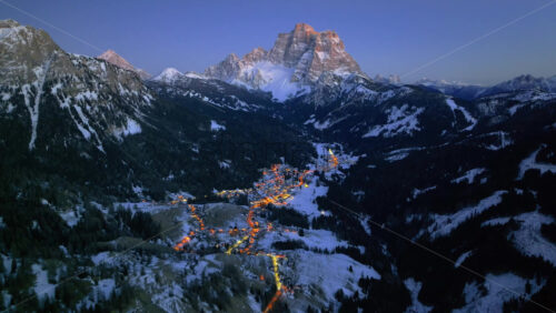 Video – Aerial drone view of the Selva di Cadore comune illuminated at night in the province of Belluno, Dolomites, Italy - Starpik Stock