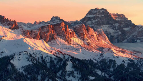Video Aerial drone view of snow on the mountains in the Dolomites, Italy at sunset - Starpik Stock