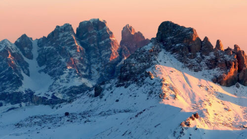 Video Aerial drone view of snow on the mountains in the Dolomites, Italy at sunset - Starpik Stock