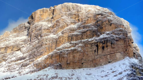video Aerial drone view of snow on the Sassongher mountain in the Dolomites, Italy with the blue sky on the background - Starpik Stock