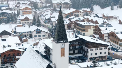 video Corvara in Badia, Italy – January 10, 2025: Aerial drone view of the houses in the Corvara in Badia village covered in snow, in South Tyrol, the Dolomites, Italy - Starpik Stock
