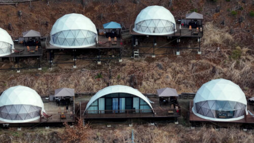 Aerial drone view of glamping cabins nea - Starpik Stock