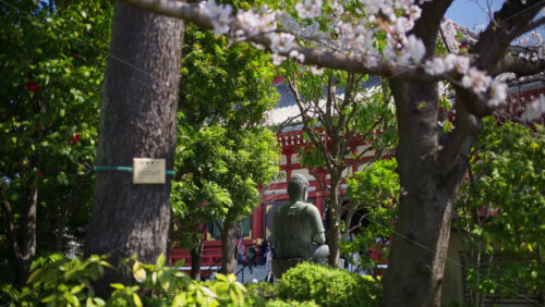 Buddhist sculpture surrounded by trees in Asakusa, Tokyo, Japan - Starpik Stock