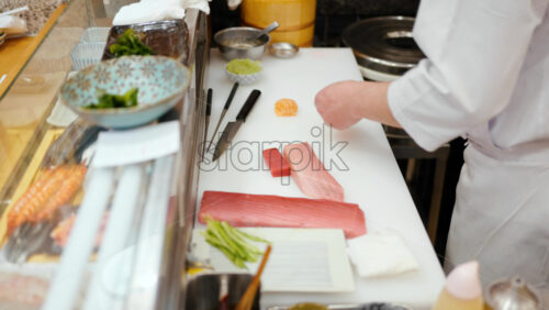 Close up of a chef cutting fish at the Tsukiji Fish Market in Japan - Starpik Stock