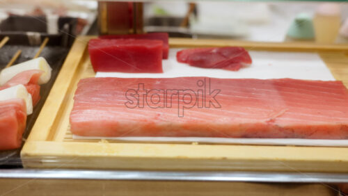 Close up of a piece of tuna in restaurant at the Tsukiji Fish Market in Japan - Starpik Stock