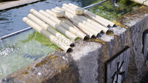 Close up of a purification fountain in the court of the Tsukiji Hongan-ji Temple in Chuo, Japan - Starpik Stock