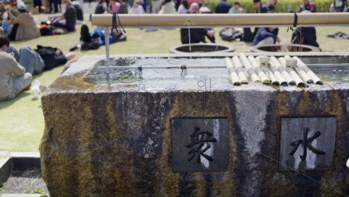 Close up of a purification fountain in the court of the Tsukiji Hongan-ji Temple in Chuo, Japan - Starpik Stock