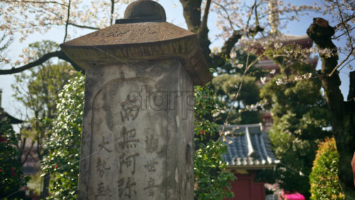 Close up of a stone pillar in the courtyard of the Senso-ji temple in Asakusa, Japan - Starpik Stock