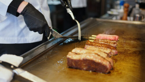 Close up of a vendor frying wagyu beef at the Tsukiji Fish Market in Chuo, Japan - Starpik Stock