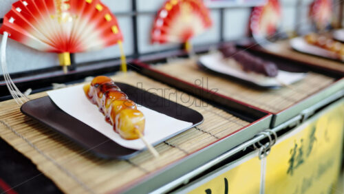 Close up of dango served on a skewer at a street food market in Japan - Starpik Stock