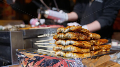 Close up of grilled fish on skewers at the Tsukiji Fish Market in Chuo, Tokyo, Japan - Starpik Stock