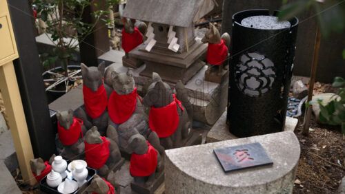 Close up of multiple Japanese fox statues in a temple - Starpik Stock