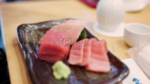 Close up of multiple pieces of tuna sashimi at the Tsukiji Fish Market in Japan - Starpik Stock